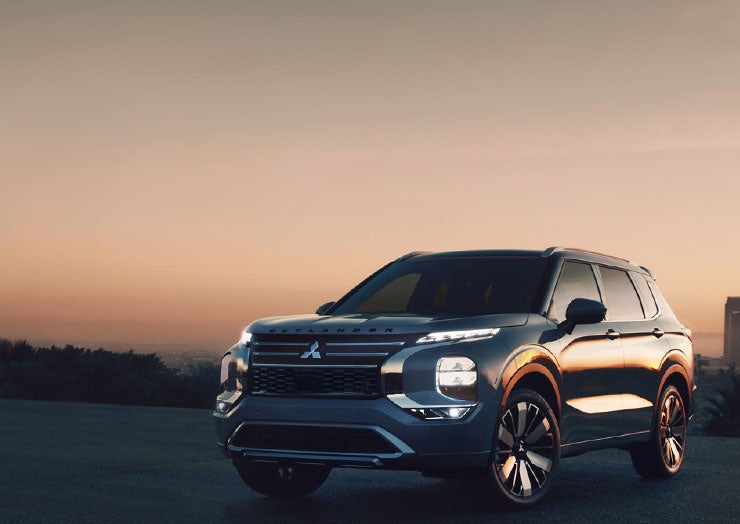 Still shot of a silver 2026 Outlander in a driveway